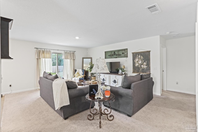 carpeted living room featuring baseboards and visible vents