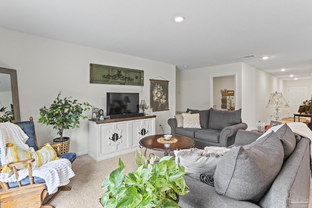 living area featuring visible vents and recessed lighting