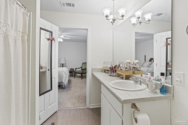 bathroom with ensuite bathroom, vanity, and visible vents