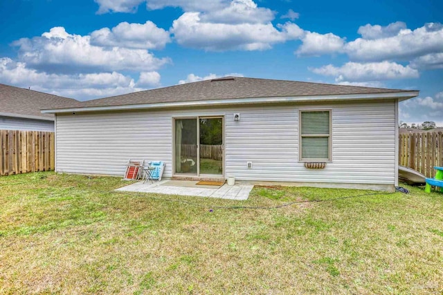 back of property with a patio area, fence, and a lawn