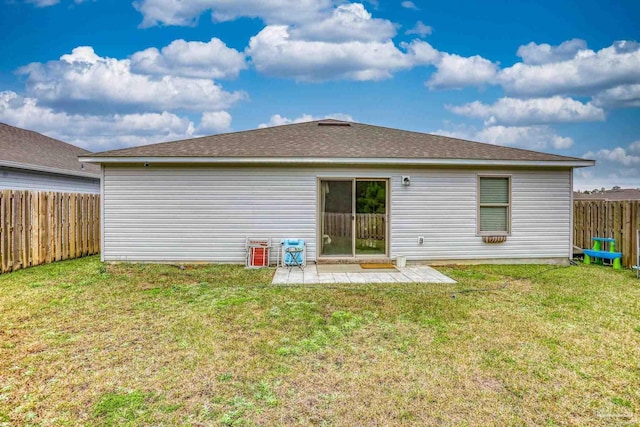 rear view of house with a patio, a lawn, and a fenced backyard