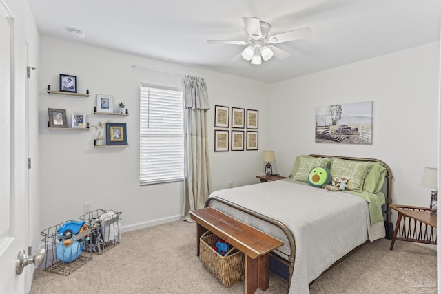 carpeted bedroom with ceiling fan and baseboards