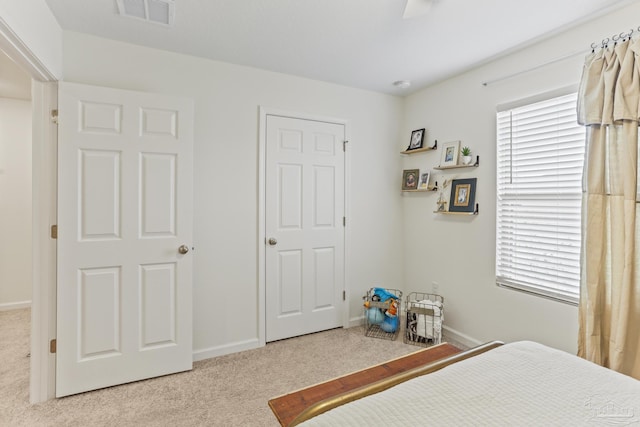 carpeted bedroom with visible vents and baseboards