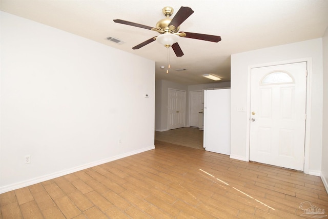 empty room featuring light wood-type flooring and ceiling fan