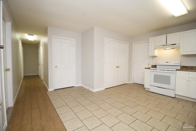 kitchen featuring white cabinets and white range with electric stovetop