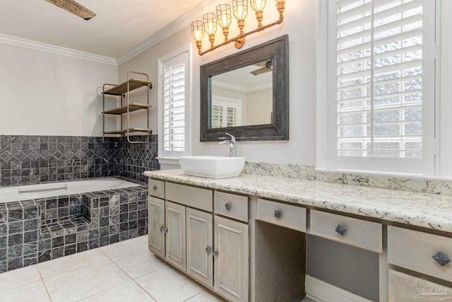 bathroom with tile patterned flooring, vanity, ornamental molding, and tiled bath