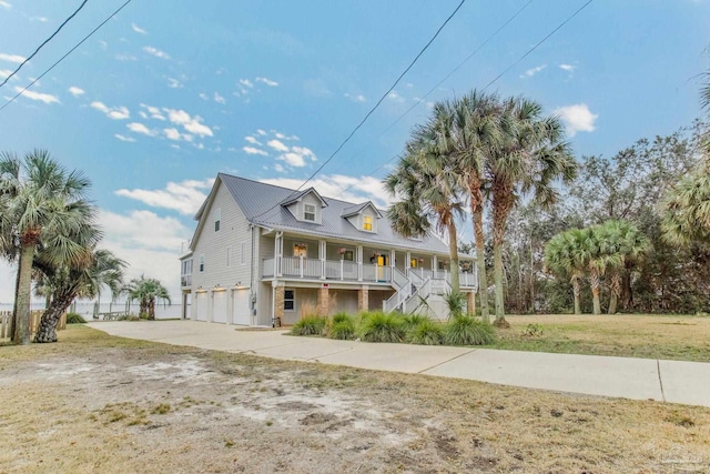 view of front facade featuring a porch, a garage, and a front lawn