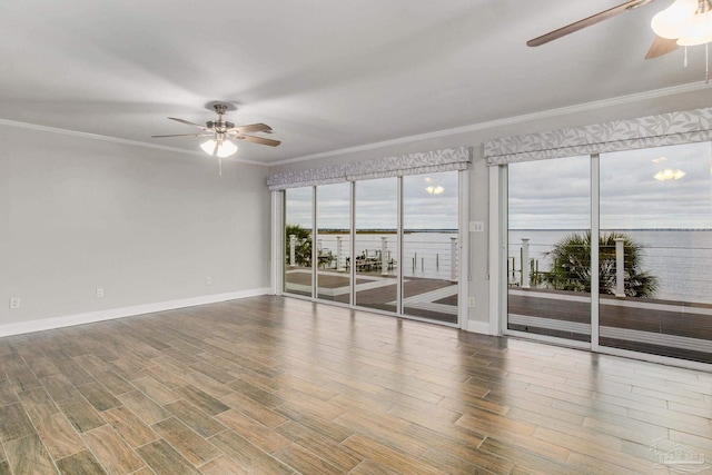 unfurnished room featuring a water view, ceiling fan, and ornamental molding