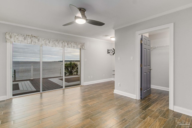 unfurnished room with ceiling fan and ornamental molding