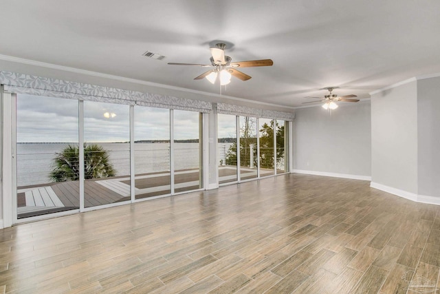 spare room with a water view, ceiling fan, and ornamental molding