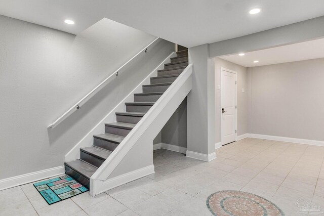 staircase featuring tile patterned floors