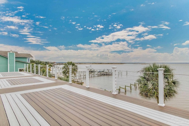 wooden terrace featuring a dock and a water view