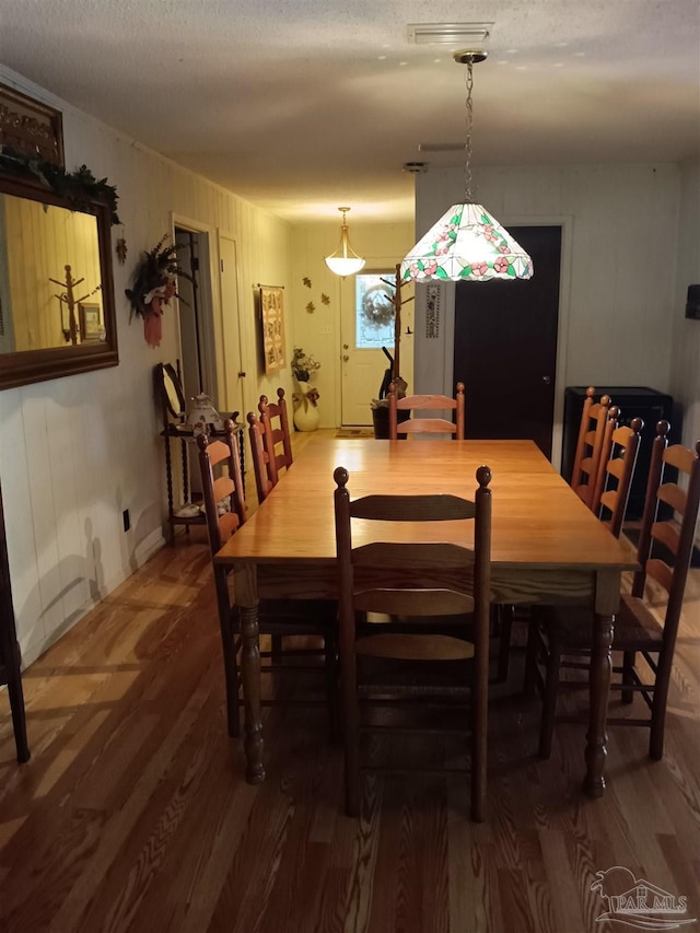 4801 Berryhill Rd, Milton, FL 32570 - dining space with a textured ceiling, wood finished floors, and visible vents
