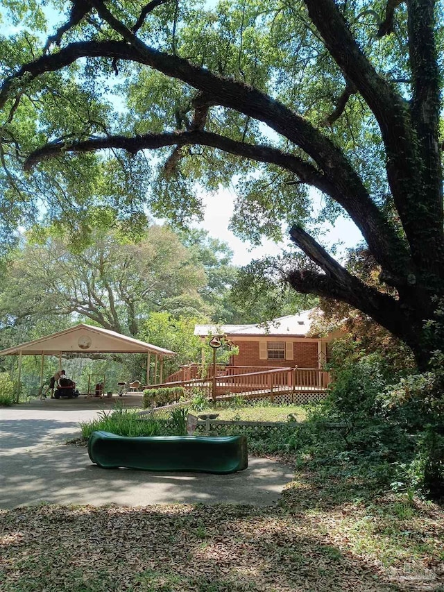 4801 Berryhill Rd, Milton, FL 32570 - view of yard featuring a carport and a deck