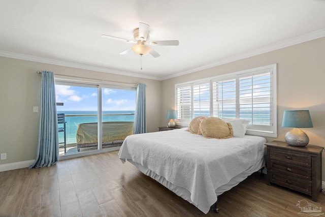 bedroom featuring a water view, wood-type flooring, crown molding, and access to outside