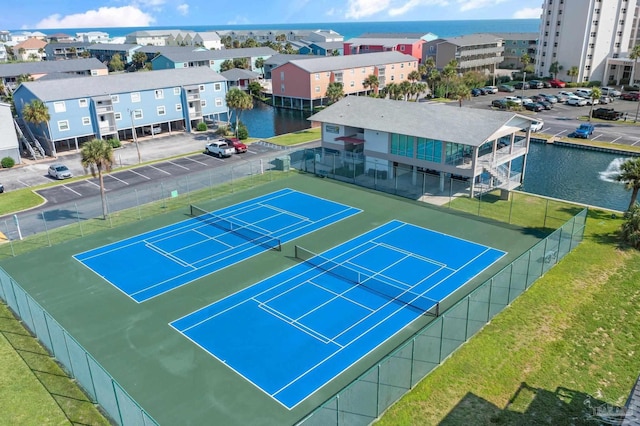 view of sport court with a water view