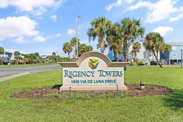 community / neighborhood sign with a lawn