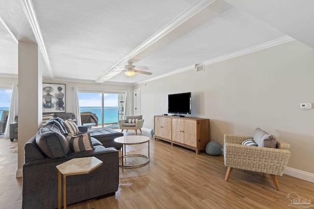 living room with ornamental molding, a textured ceiling, ceiling fan, and light hardwood / wood-style floors