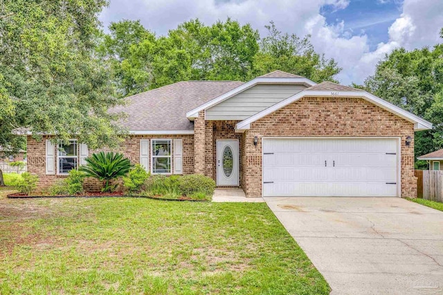5661 Maggie Rose Cir, Milton, FL 32570 - ranch-style house with driveway, a garage, and brick siding