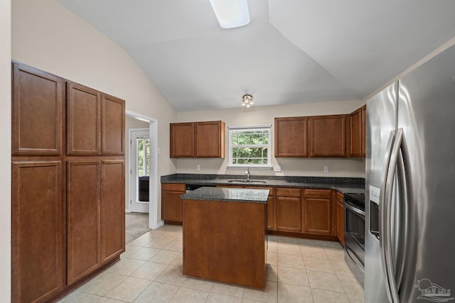 5661 Maggie Rose Cir, Milton, FL 32570 - kitchen featuring appliances with stainless steel finishes, vaulted ceiling, a kitchen island, light tile patterned floors, and dark stone counters