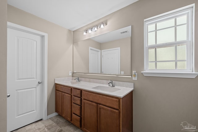 5661 Maggie Rose Cir, Milton, FL 32570 - bathroom with double vanity and baseboards