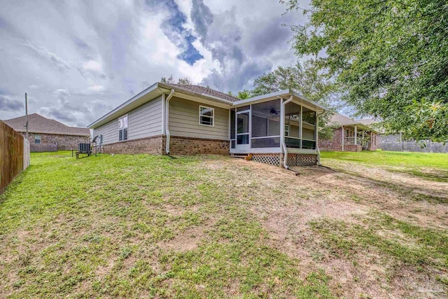 5661 Maggie Rose Cir, Milton, FL 32570 - rear view of property with a sunroom, a ceiling fan, and brick siding