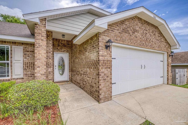 5661 Maggie Rose Cir, Milton, FL 32570 - view of front facade featuring brick siding, a garage, and concrete driveway