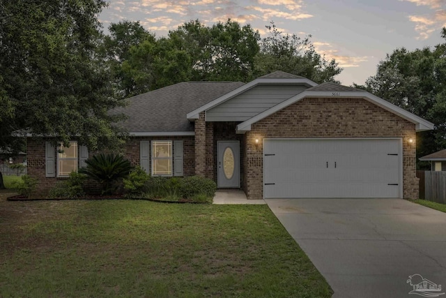 5661 Maggie Rose Cir, Milton, FL 32570 - ranch-style home featuring brick siding, a garage, driveway, and a shingled roof
