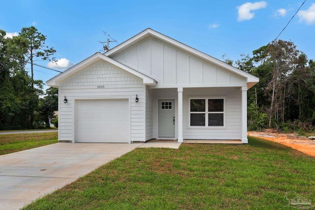 view of front facade featuring a front yard, board and batten siding, concrete driveway, and an attached garage