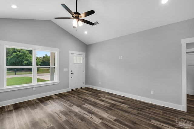 interior space with dark wood-type flooring, vaulted ceiling, baseboards, and ceiling fan
