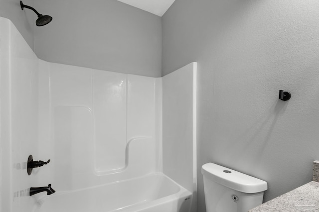 bathroom featuring shower / bathing tub combination and toilet