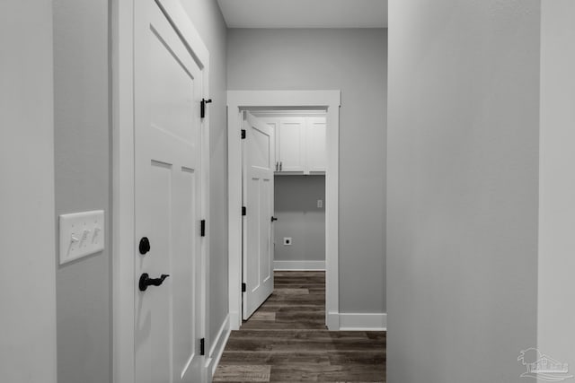 hallway with baseboards and dark wood finished floors