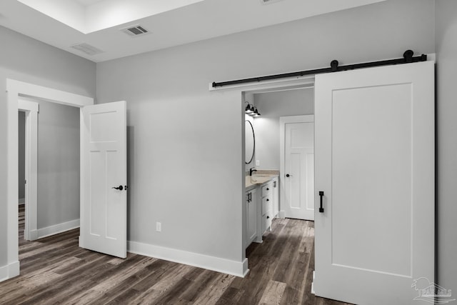 unfurnished bedroom featuring dark wood finished floors, visible vents, and baseboards