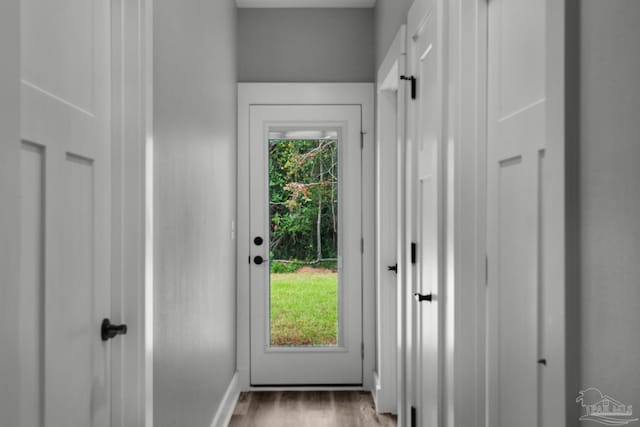 entryway with wood finished floors and baseboards