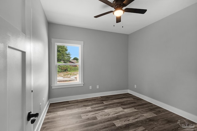empty room with ceiling fan, baseboards, and dark wood-style flooring