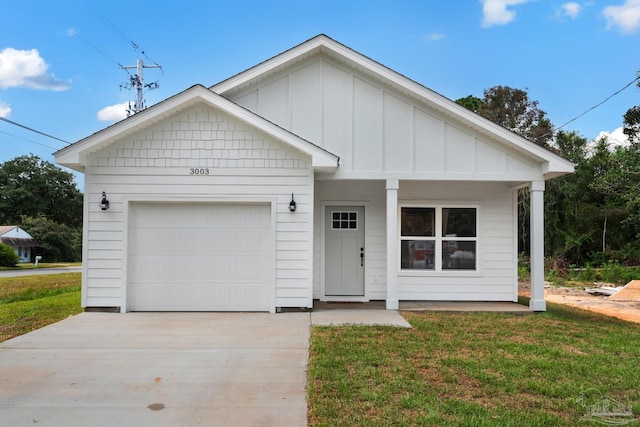 view of front of house featuring board and batten siding, concrete driveway, a garage, and a front yard
