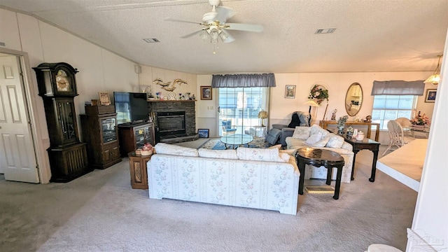 living room featuring a textured ceiling, carpet floors, and ceiling fan