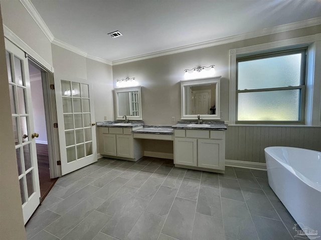 bathroom featuring a bathing tub, tile patterned flooring, vanity, crown molding, and french doors