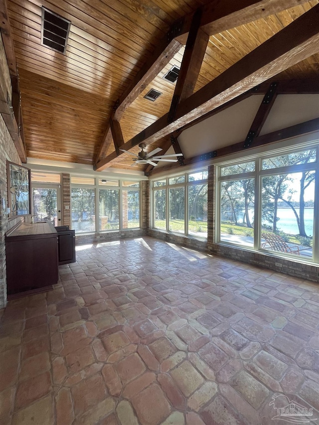 unfurnished sunroom with ceiling fan, lofted ceiling with beams, and wooden ceiling