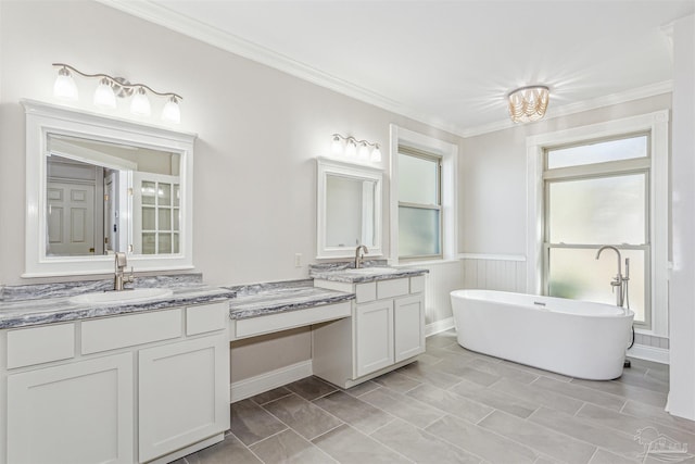 bathroom featuring ornamental molding, a bathing tub, tile patterned flooring, and vanity