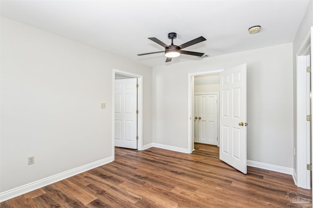 unfurnished bedroom featuring ceiling fan and dark hardwood / wood-style floors