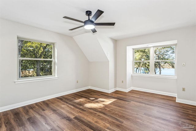 additional living space with ceiling fan, dark hardwood / wood-style flooring, and vaulted ceiling