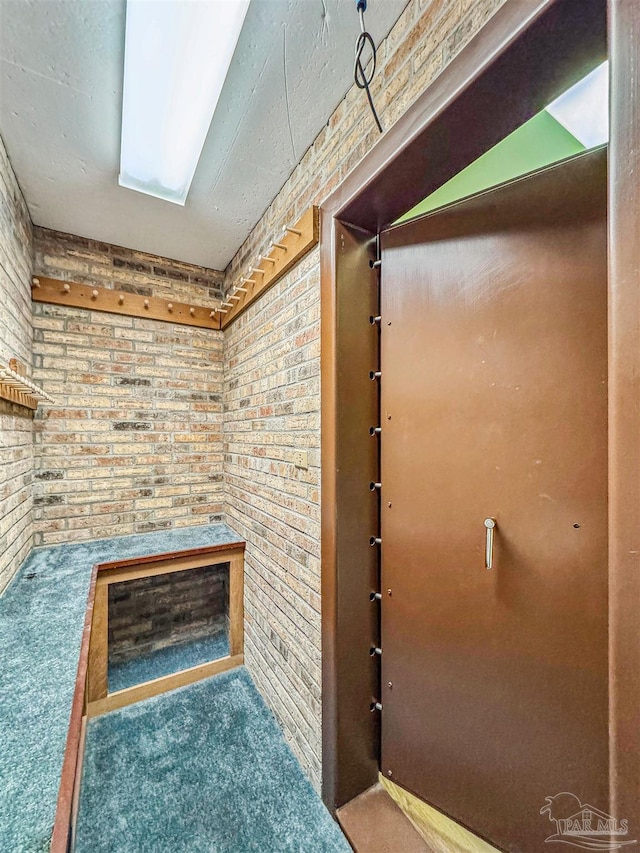 bathroom featuring brick wall