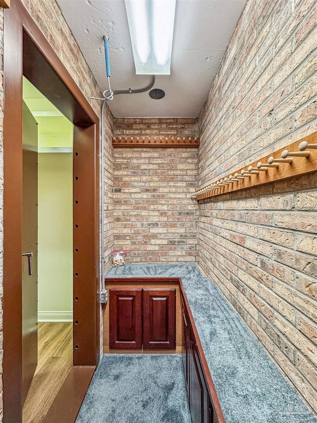 bar with light carpet and brick wall