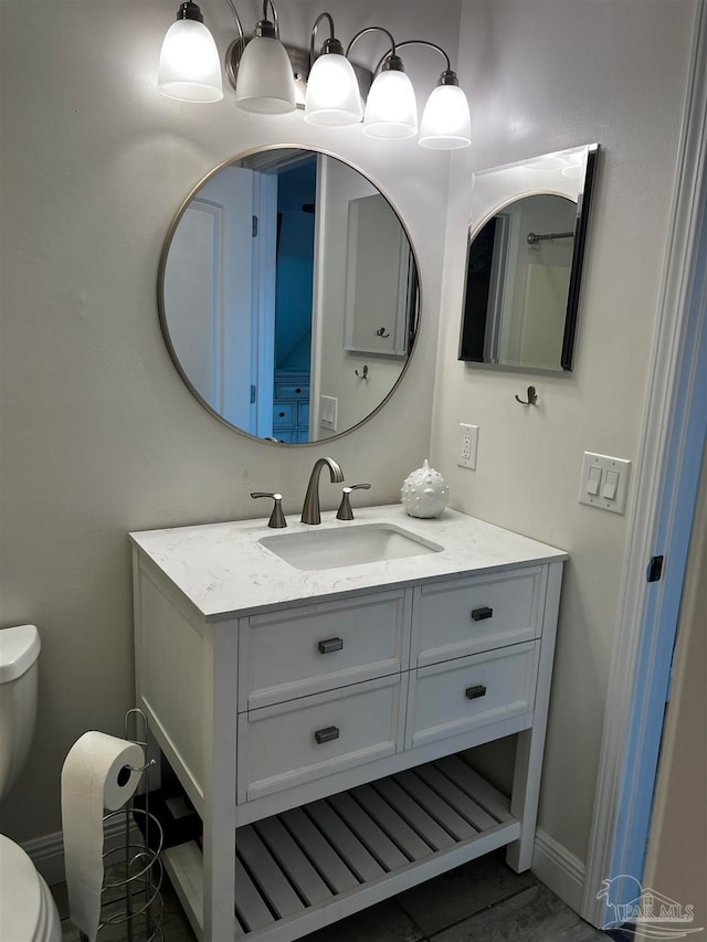 bathroom featuring tile patterned floors, vanity, and toilet