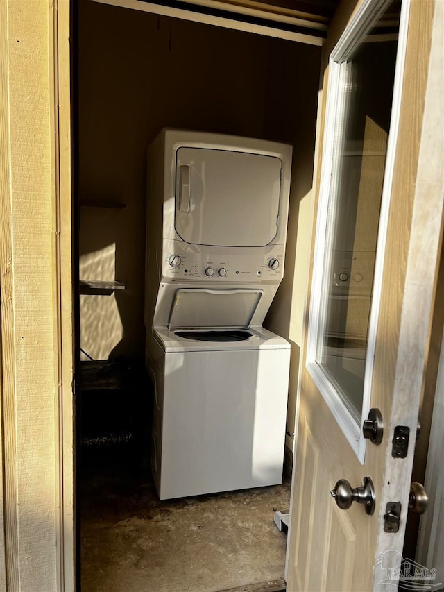 laundry area with stacked washer and clothes dryer