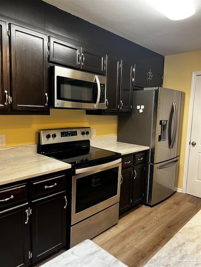 kitchen with appliances with stainless steel finishes and light wood-type flooring