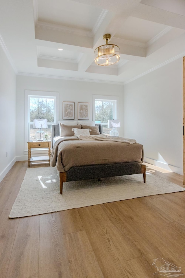 bedroom with crown molding, a notable chandelier, multiple windows, and light hardwood / wood-style flooring