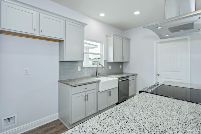 kitchen with light stone counters, a sink, backsplash, stainless steel dishwasher, and exhaust hood