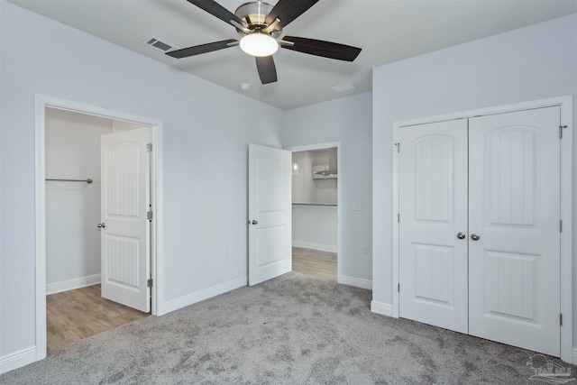 unfurnished bedroom with visible vents, a ceiling fan, a closet, carpet, and baseboards